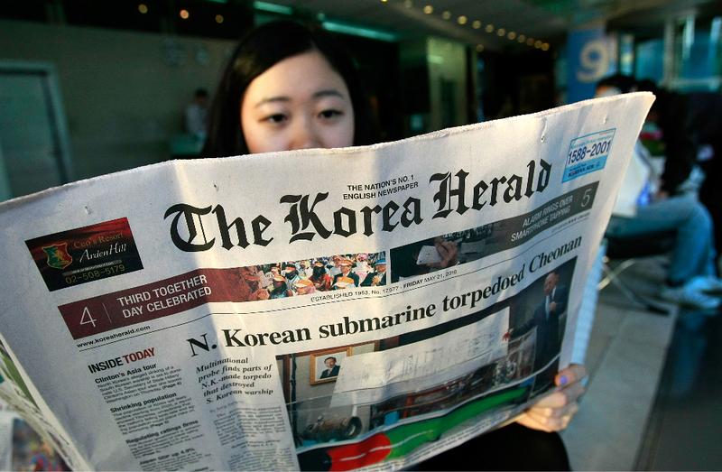 A South Korean woman reads a newspaperin Seoul, South Korea.